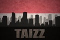 Abstract silhouette of the city with text Taizz at the vintage yemen flag Royalty Free Stock Photo