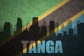 Abstract silhouette of the city with text Tanga at the vintage tanzanian flag