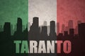Abstract silhouette of the city with text Taranto at the vintage italian flag