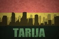 Abstract silhouette of the city with text Tarija at the vintage bolivian flag Royalty Free Stock Photo