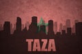 Abstract silhouette of the city with text Taza at the vintage moroccan flag