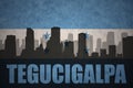 Abstract silhouette of the city with text Tegucigalpa at the vintage honduras flag