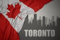 Abstract silhouette of the city with text Toronto near waving national flag of canada on a gray background Royalty Free Stock Photo
