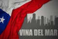 Abstract silhouette of the city with text Vina del Mar near waving national flag of chile on a gray background