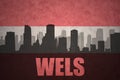 Abstract silhouette of the city with text Wels at the vintage austrian flag Royalty Free Stock Photo