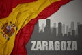 Abstract silhouette of the city with text Zaragoza near waving national flag of spain on a gray background