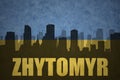 Abstract silhouette of the city with text Zhytomyr at the vintage ukrainian flag