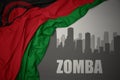 Abstract silhouette of the city with text Zomba near waving colorful national flag of malawi on a gray background