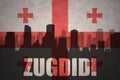 Abstract silhouette of the city with text Zugdidi at the vintage georgian flag
