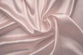 Abstract silk background. Soft pink shiny fabric. Delicate rose textile texture. Satin folds, waves pattern. Pastel silky backdrop Royalty Free Stock Photo