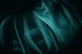 Abstract silk teal waves on dark background