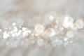 Abstract silver background texture with blurred white bokeh light circles.