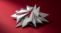 Abstract silver brooch featuring sharp triangular forms and varied metallic textures arranged dynamically on a deep red surface Royalty Free Stock Photo