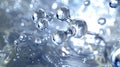 Abstract silver bubbles in water, shiny and reflective with bokeh effect Royalty Free Stock Photo