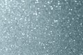 Abstract silver glitter or blur light effect background. Glittering silver grain or shining particles texture with sparkling snow Royalty Free Stock Photo