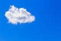 Abstract sky background in blue with one single fluffy soft white cloud and copy space Royalty Free Stock Photo