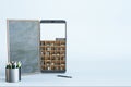 Abstract smartphone with online library on light background with mock up place. Digital education and knowledge concept. Royalty Free Stock Photo