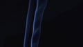 Abstract smoke cloud. Blue smoke slowly floating through space against black background. Close up. Slow motion.