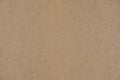 Abstract, solid brown cardboard background.