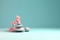 Stack of balanced zen stones, gray and white pebbles pyramid with pink cherry flowers Royalty Free Stock Photo