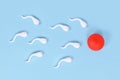 Abstract sperm cells swimming towards egg cell