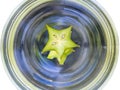 Abstract spinning water with star apple in bowl isolated on whit Royalty Free Stock Photo