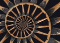 Abstract spiral wooden wagon cannon wheel black metal brackets rivets. Wheel wooden spokes fractal background. Horse vehicle wheel Royalty Free Stock Photo