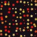 Abstract stars seamless pattern in yellow orange and red on dark background Royalty Free Stock Photo