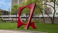 Abstract steel sculpture painted red at 3333 Lee Parkway in Dallas, Texas.