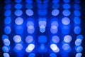 Abstract symmetric glitter defocused blue lights bokeh texture on black background