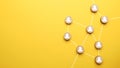 Abstract teamwork, network and community concept on a yellow paper background