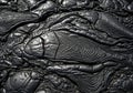 Abstract texture background of black solidified pahoehoe lava with cracks and wavy patterns Royalty Free Stock Photo