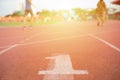 Abstract texture and background of empty running track with number one on the floor in foreground and defocused people exercising