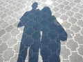 Abstract texture background with shadows of walking couple citizens on asphalt sidewalk Royalty Free Stock Photo