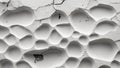 Abstract texture of cracked white surface with irregular holes and depressions suitable for backgrounds and design Royalty Free Stock Photo