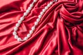 Abstract texture of draped red silk background with pearls Royalty Free Stock Photo