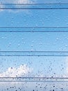 Abstract texture of drops of rain on a window glass. Clean background view of water drops on glass over a blue sky. Rain water Royalty Free Stock Photo