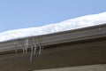 Abstract texture of icicles hanging down from a modern rain gutter in early spring