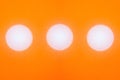 Abstract texture of multiple water drops on orange background with three white circles Royalty Free Stock Photo