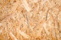 abstract textured background of compressed plywood. texture of light brown pressed wooden board chipboard. top view, close up.
