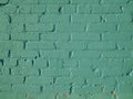 Abstract textured background of old brick wall painted with light green paint closeup Royalty Free Stock Photo