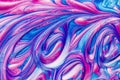 An abstract textured background of pink and blue metallic glitter paint swirls Royalty Free Stock Photo