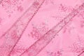 Abstract textured background of pink net ribbon with glitter snowflakes Royalty Free Stock Photo