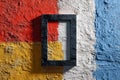 Abstract textured wall painted in red, yellow, white, and blue with a black rectangular frame creating bold geometric contrast and Royalty Free Stock Photo
