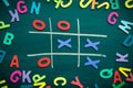Abstract Tic Tac Toe Game Competition with Wood Alphabet letters. XO Win Challenge Concept on black board Royalty Free Stock Photo