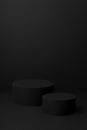 Abstract two black round podiums for cosmetic products, mockup on black background, vertical.