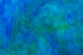 Abstract underwater color background. Color drop underwater creating a silk drapery Royalty Free Stock Photo