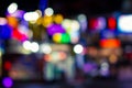 Abstract unfocused blurred background of night city lights illumination in darkness