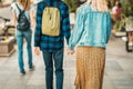 Abstract unrecognizable couple in love back to us walking in the city holding hands, romantic walk Royalty Free Stock Photo