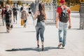 Abstract unrecognizable girl and guy walking together on city street. Concept of modern City life, love, lifestyle